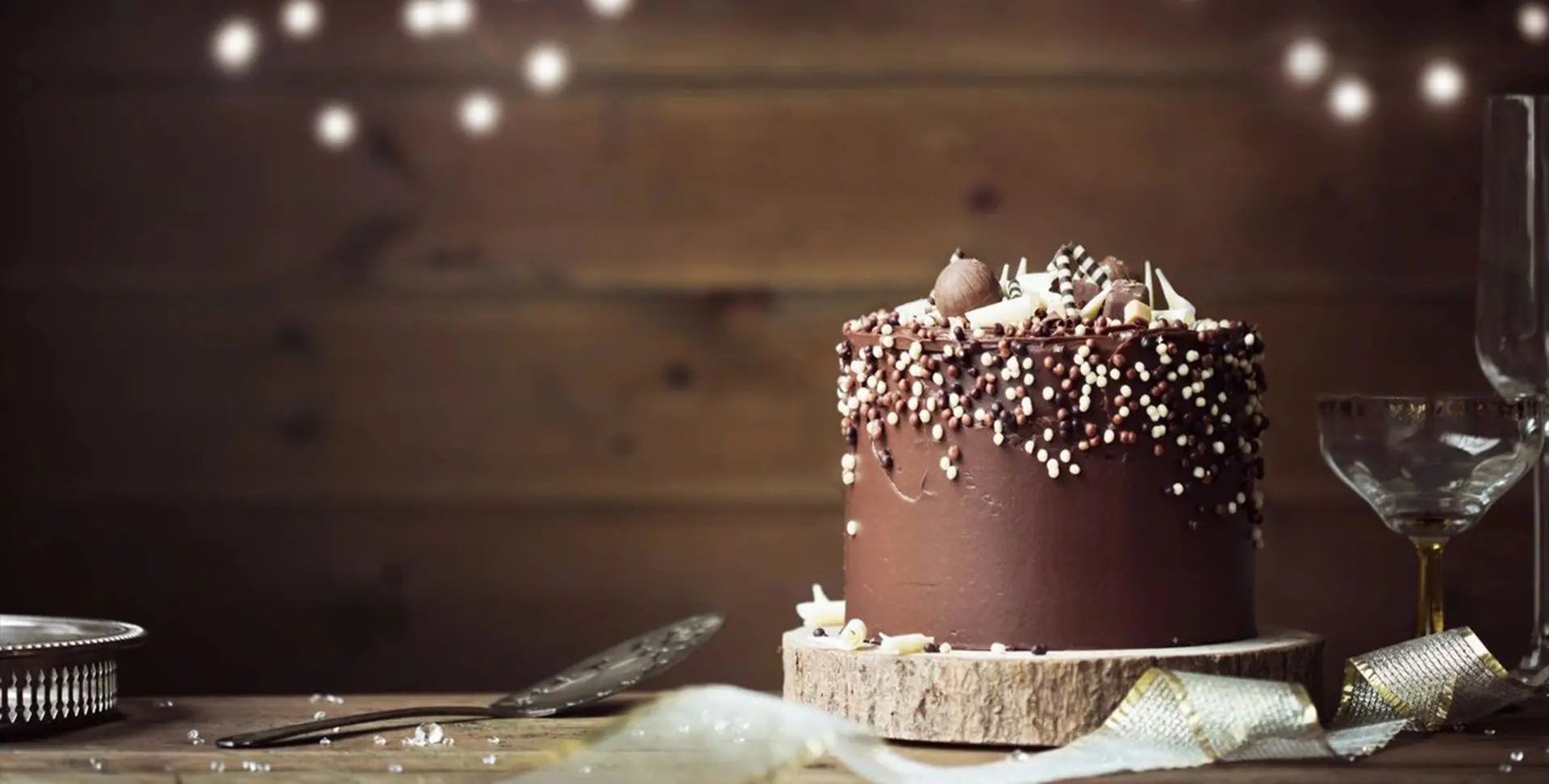 A chocolate cake with white sprinkles on top of it.