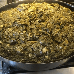 A pan of food on the stove top.