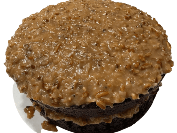 A close up of a cake with chocolate frosting and caramel.