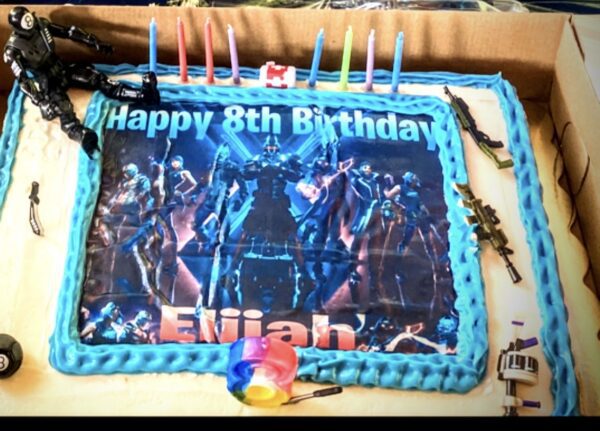 A birthday cake with a picture of the avengers on it.