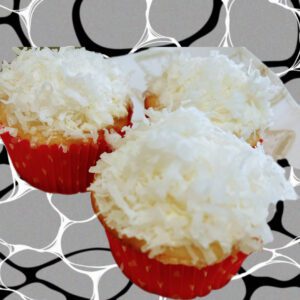 Three cupcakes with white frosting on top of a black and white background.