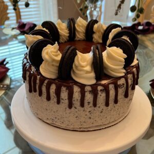 A cake with chocolate and white frosting on top of a table.