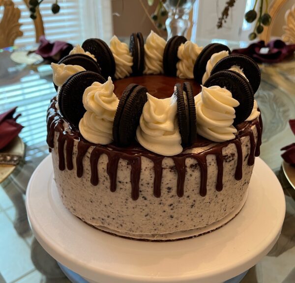 A cake with chocolate and white frosting on top of a table.