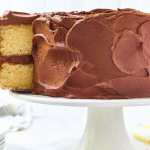 A cake sitting on top of a white pedestal.