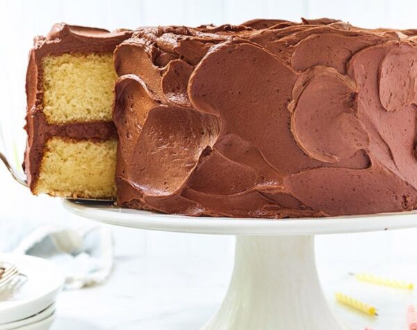 A cake sitting on top of a white pedestal.