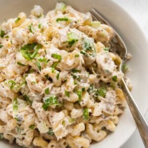 A bowl of macaroni salad with green onions.