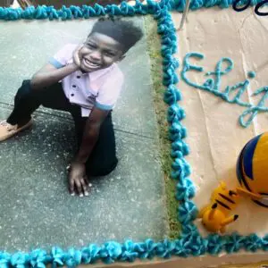 A cake with a picture of a boy on it.