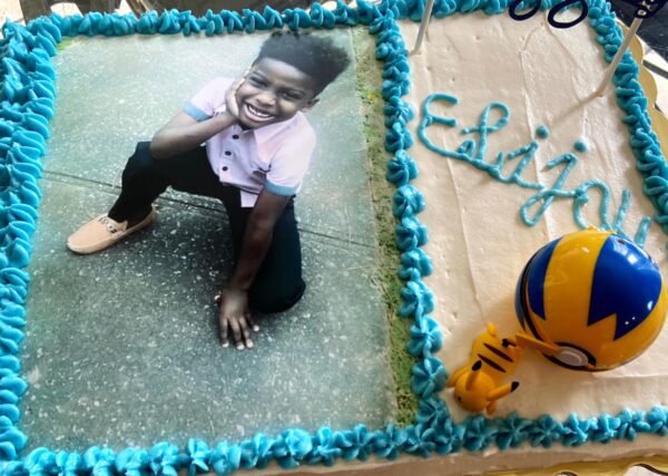 A cake with a picture of a boy on it.