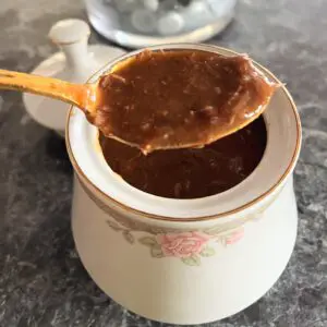 A spoon in a bowl of coffee on the counter.