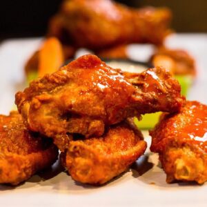 A close up of some chicken wings on a plate