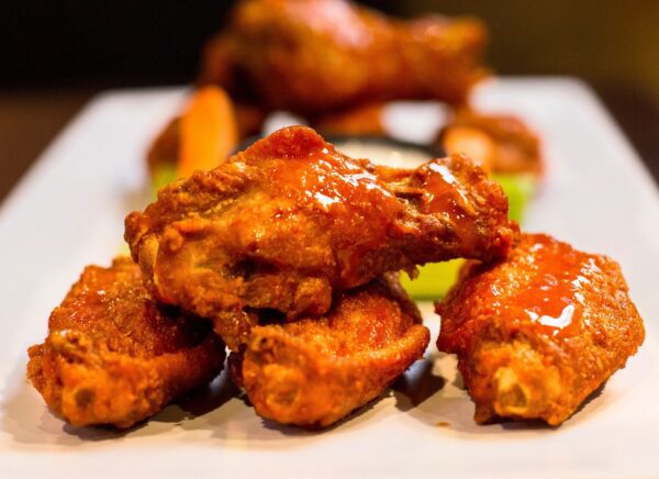 A close up of some chicken wings on a plate