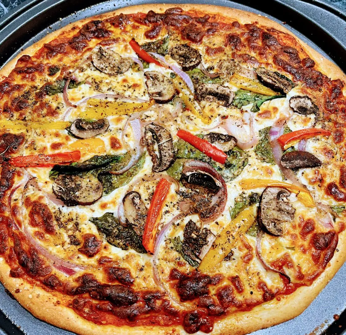 A pizza with mushrooms, peppers and onions on it.