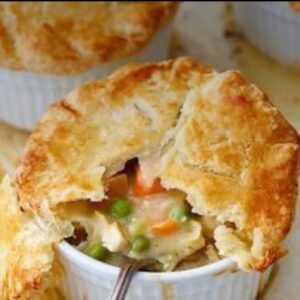 A close up of a pot pie in a white bowl