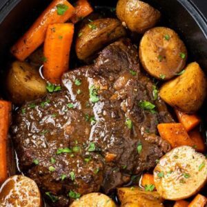 A pot roast with potatoes and carrots in it.