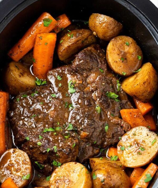 A pot roast with potatoes and carrots in it.