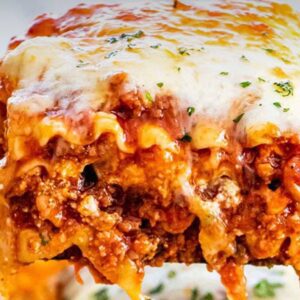 A close up of lasagna with cheese on top