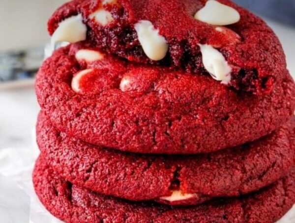 A stack of red velvet cookies with white chocolate chips.